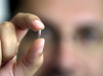 Antonio Aceves shows the VeriChip which is a microchip that can be implanted under a person's skin and used to confirm everything from health history to identity July 1, 2003, in Mexico City. The microchips, which went on sale last year in the United States, could tap into a growing industry surrounding Mexico's crime concerns. (AP Photo/Jose Luis Magana)